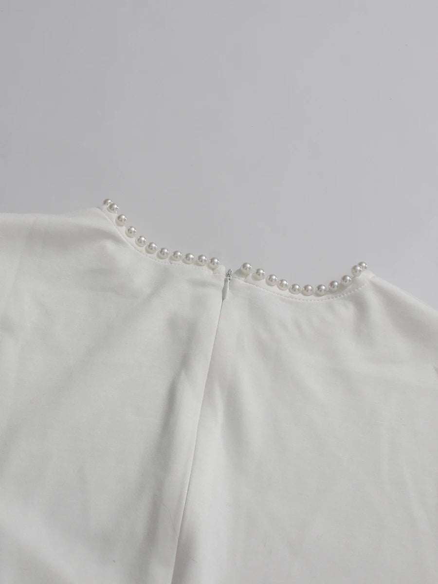 Henny Abaya mit Perlen