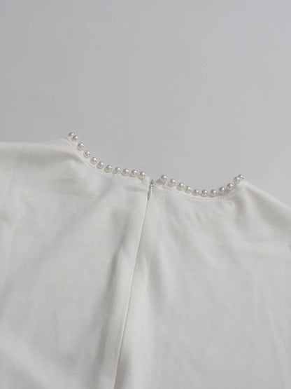 Henny Abaya mit Perlen